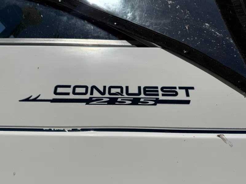 Slide: The Image of Boston Whaler 255 Conquest 2002 boat logo on white surface. - 44