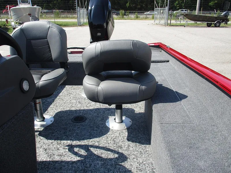 Slide: The Image of 2026 Tracker Super Guide V-16 SC boat interior with gray seating and carpeted floor. - 12