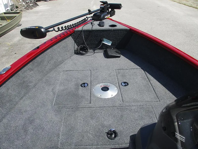 Slide: The Image of 2026 Tracker Super Guide V-16 SC boat interior with trolling motor and carpeted deck. - 16