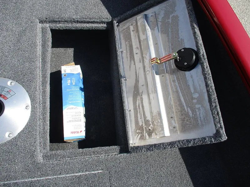 Slide: The Image of 2026 Tracker Super Guide V-16 SC boat storage compartment with a carton inside. - 21