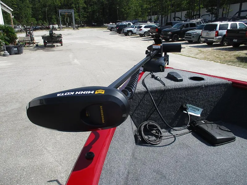 Slide: The Image of 2026 Tracker Super Guide V-16 SC with Minn Kota trolling motor in parking lot. - 22