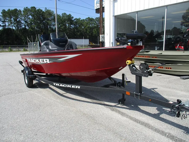 Slide: The Image of 2026 Tracker Super Guide V-16 SC boat in red on a trailer, parked outdoors. - 5
