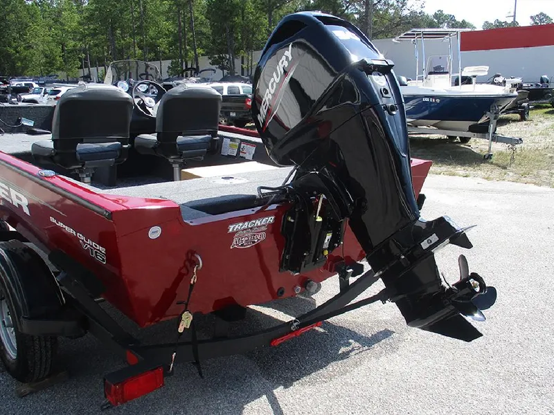 Slide: The Image of 2026 Tracker Super Guide V-16 SC boat with Mercury outboard motor, parked outdoors. - 8