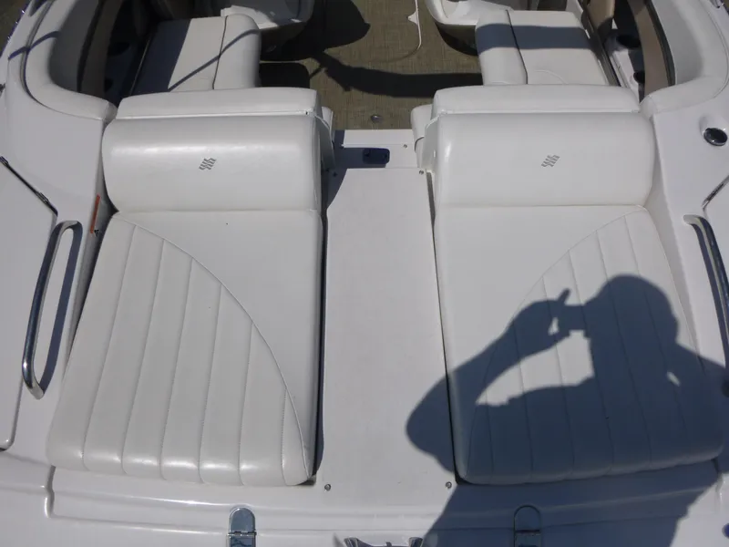 Slide: The Image of 2006 Four Winns 220 Horizon boat interior with white leather seats and shadow. - 13