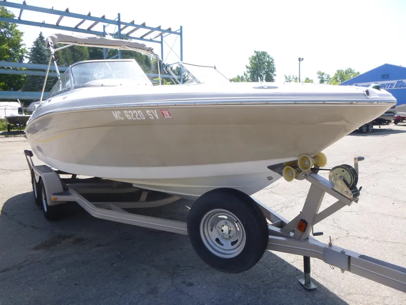 Slide: The Image of 2006 Four Winns 220 Horizon boat on trailer, parked outdoors. - 3