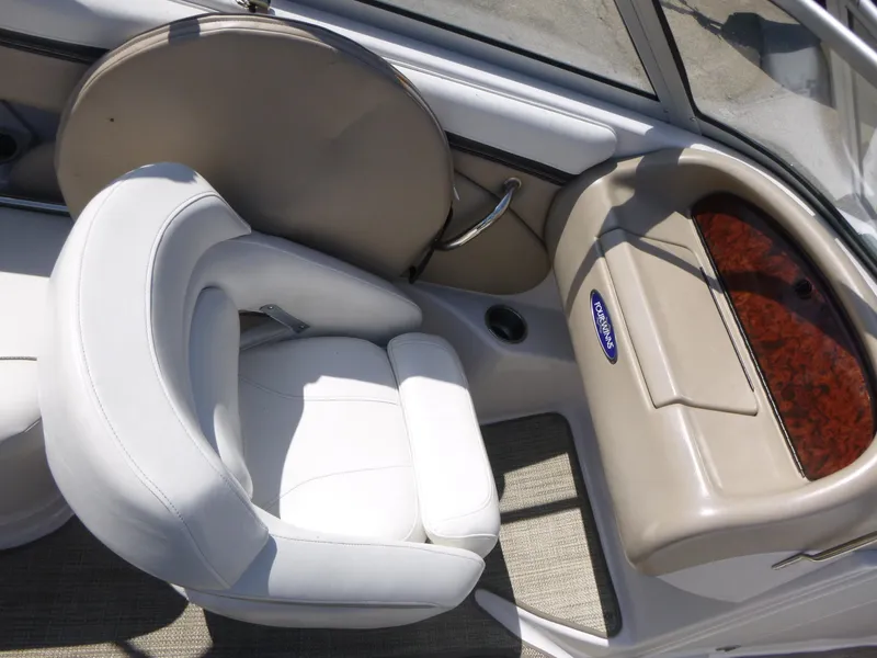 Slide: The Image of 2006 Four Winns 220 Horizon boat interior with white seating and dashboard. - 9
