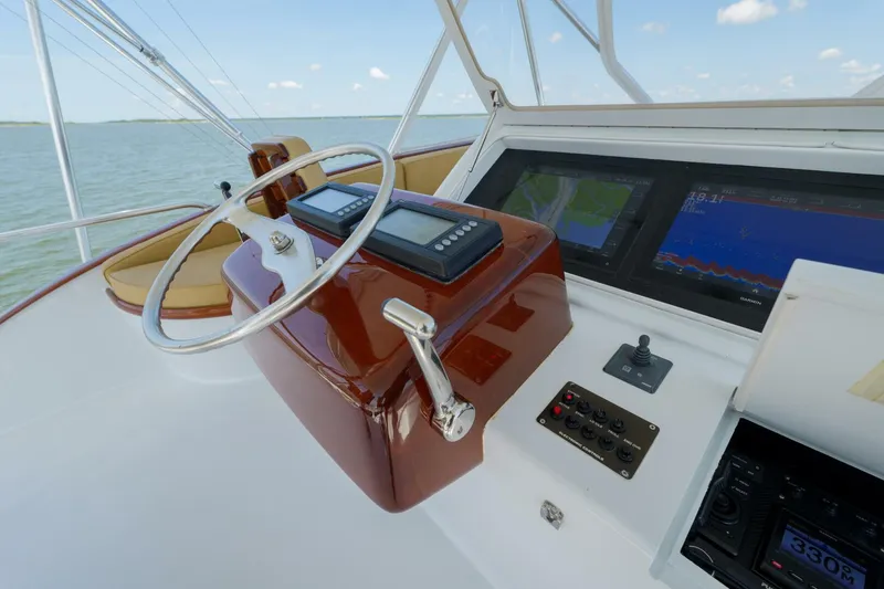 Slide: The Image of Helm of 2000 Garlington 61 C yacht with navigation screens and controls. - 11