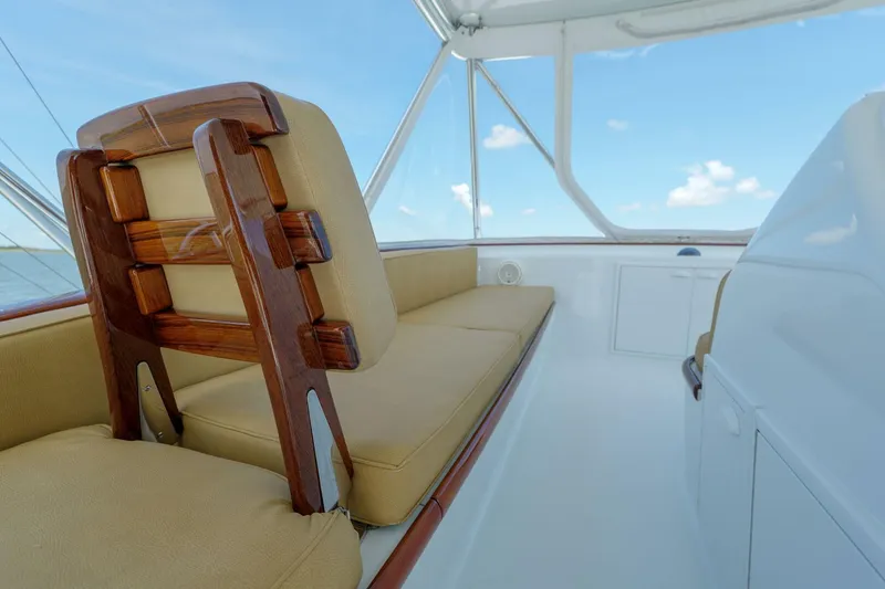 Slide: The Image of Interior of 2000 Garlington 61 C yacht with cushioned seating and wooden accents. - 12