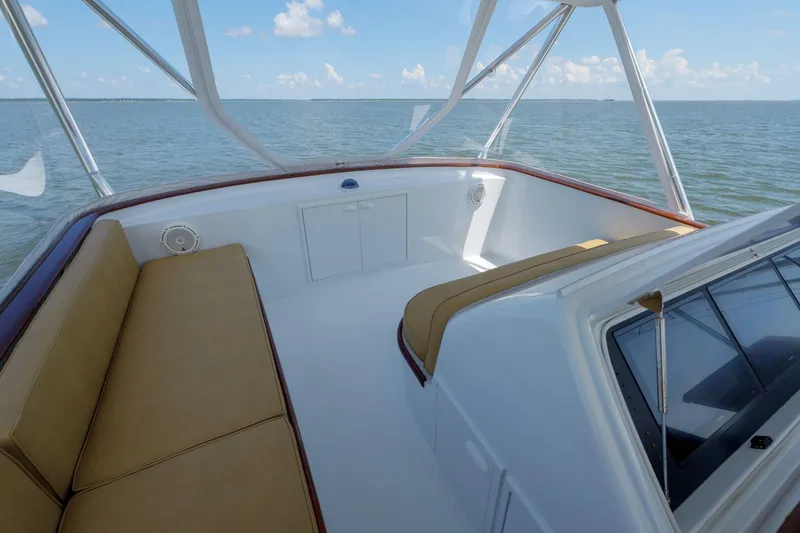 Slide: The Image of Luxurious Garlington 61 C yacht interior with tan seating, overlooking serene ocean waters. - 13