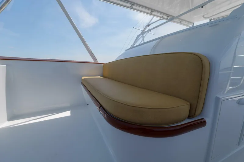 Slide: The Image of Beige cushioned seating on 2000 Garlington 61 C yacht deck under clear blue sky. - 14