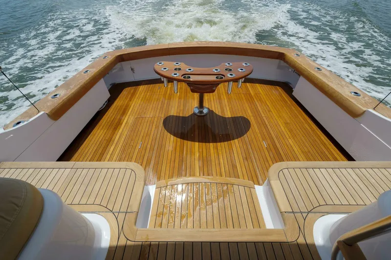 Slide: The Image of Luxurious Garlington 61 C yacht deck with wooden finish, 2000 model, cruising on water. - 18