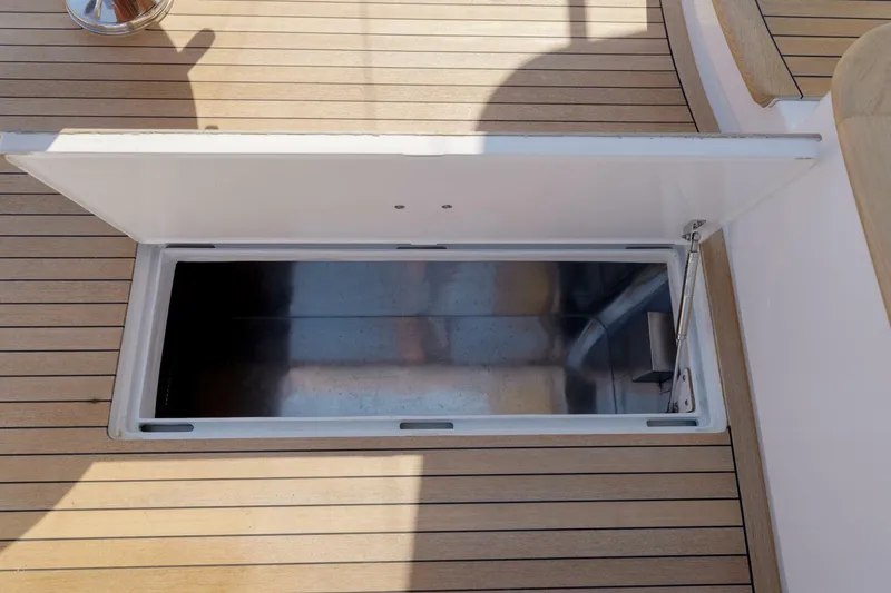Slide: The Image of Open storage compartment on Garlington 61 C yacht, 2000 model, with wooden deck. - 25