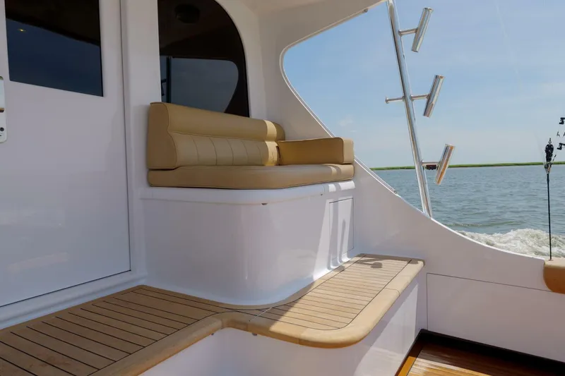 Slide: The Image of Luxury seating on a 2000 Garlington 61 C yacht, overlooking serene waters. - 26