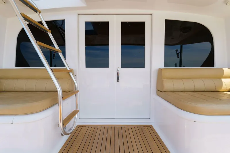 Slide: The Image of Luxury yacht interior with beige seating, wooden flooring, and metal ladder, Garlington 61 C, 2000 model. - 28