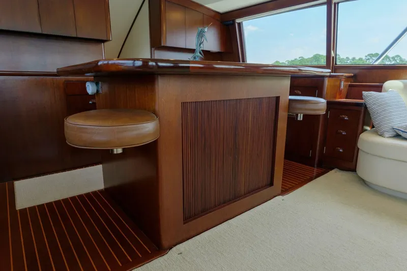 Slide: The Image of Luxurious wooden interior of a 2000 Garlington 61 C yacht with leather seating. - 32