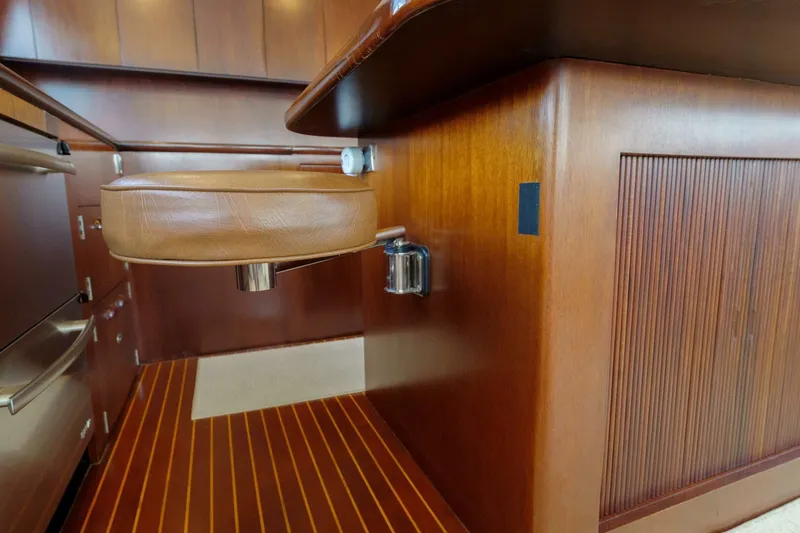 Slide: The Image of Luxurious wooden interior of a 2000 Garlington 61 C yacht with leather seating. - 33