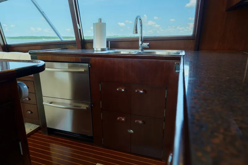 Slide: The Image of Luxurious yacht kitchen interior with wooden cabinetry and stainless steel appliances, Garlington 61 C, 2000. - 36