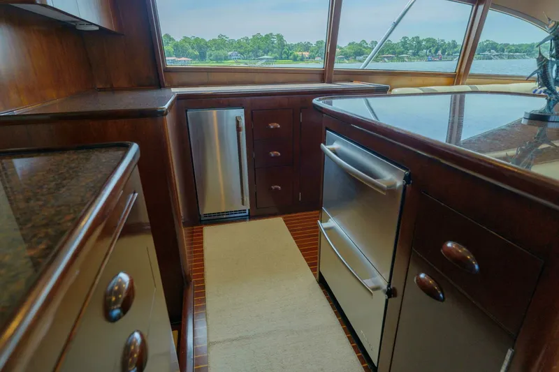 Slide: The Image of Luxurious kitchen interior of 2000 Garlington 61 C yacht with wood cabinetry and stainless appliances. - 37