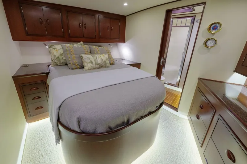 Slide: The Image of Luxurious bedroom interior in a 2000 Garlington 61 C yacht, featuring elegant wood cabinetry. - 4