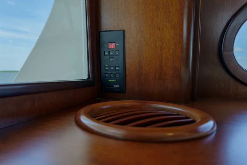 Slide: The Image of Wooden interior of a 2000 Garlington 61 C yacht with control panel and vent. - 45