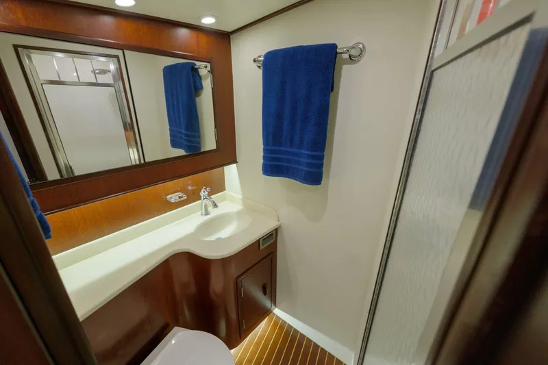 Slide: The Image of Luxurious bathroom in 2000 Garlington 61 C yacht with blue towel and modern fixtures. - 49