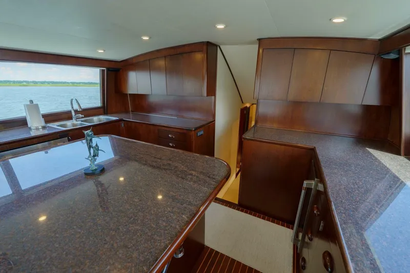Slide: The Image of Luxurious kitchen interior of 2000 Garlington 61 C yacht with wooden cabinetry and ocean view. - 5