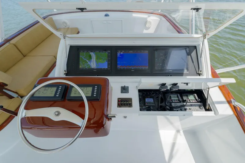 Slide: The Image of Helm of 2000 Garlington 61 C yacht with navigation screens and controls. - 8