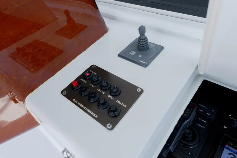 Slide: The Image of Garlington 61 C 2000 boat electronic control panel with joystick and buttons. - 9