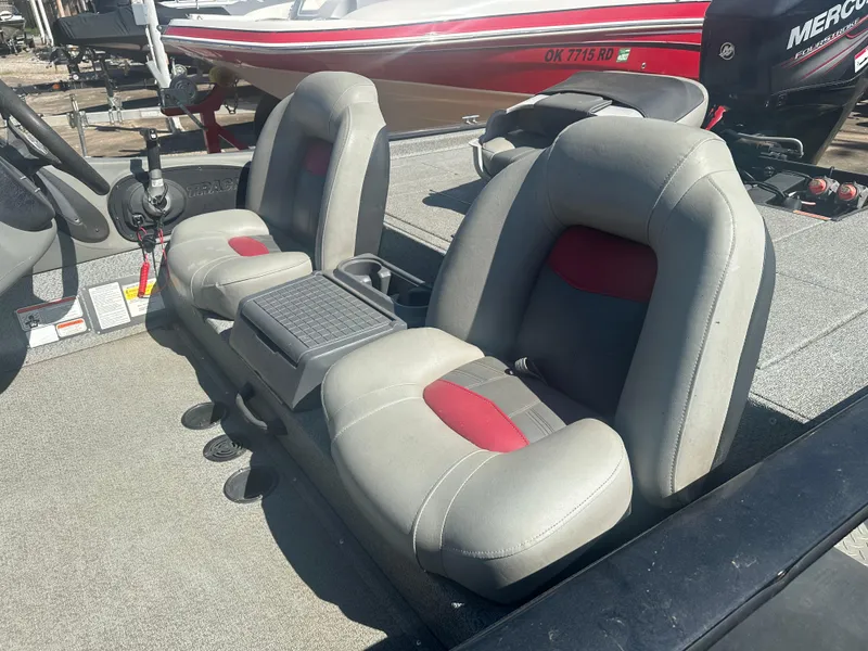 Slide: The Image of 2017 Tracker Pro Team 175 TXW boat interior with gray and red seats. - 10