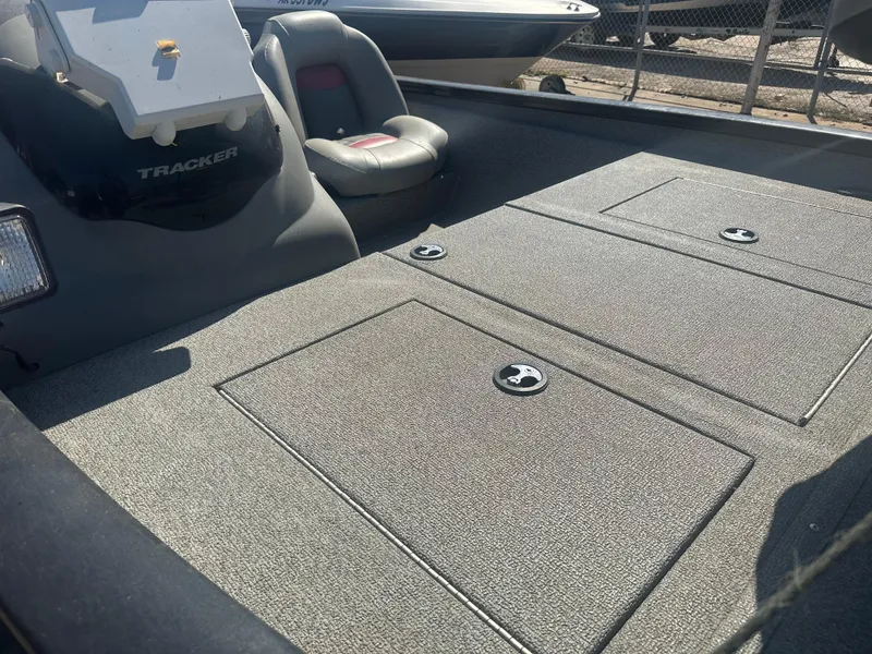 Slide: The Image of 2017 Tracker Pro Team 175 TXW boat interior with seating and storage compartments. - 3