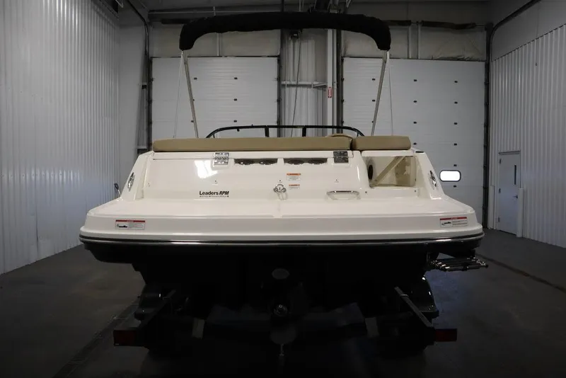 Slide: The Image of 2024 Bayliner VR5 Bowrider in a garage, rear view with bimini top. - 10