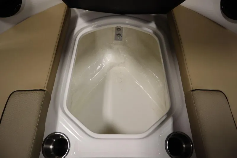 Slide: The Image of 2024 Bayliner VR5 Bowrider storage compartment with beige seating and cup holders. - 13