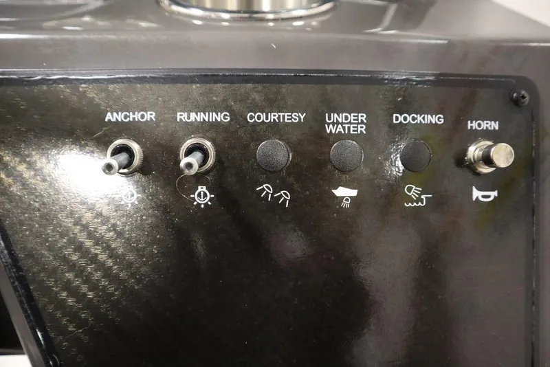 Slide: The Image of Control panel of 2024 Bayliner VR5 Bowrider with switches for anchor, lights, and horn. - 19