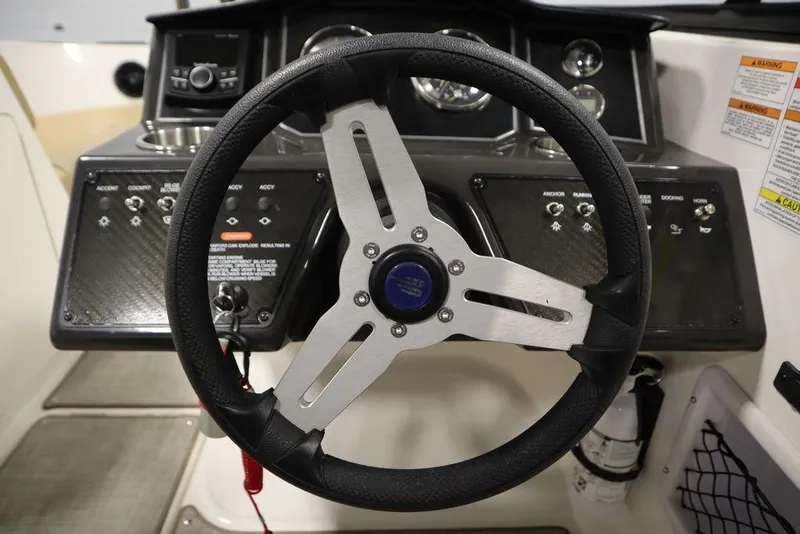 Slide: The Image of 2024 Bayliner VR5 Bowrider steering wheel and dashboard controls. - 24