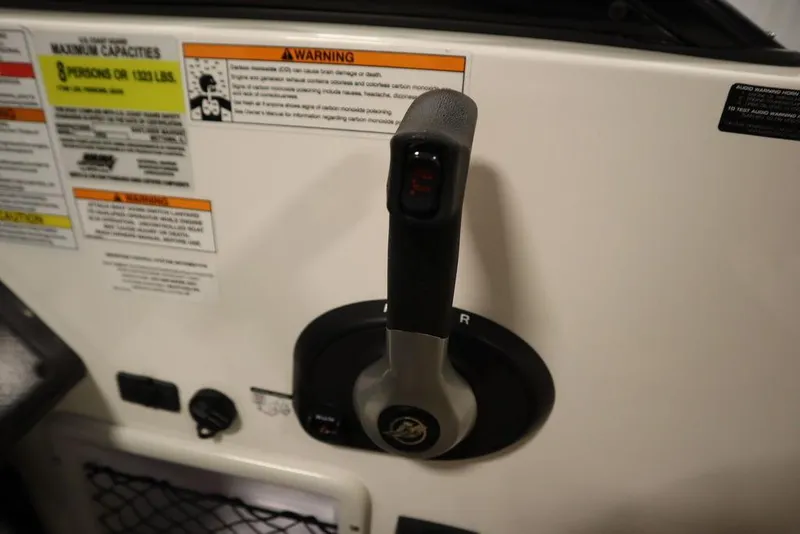 Slide: The Image of Throttle control of 2024 Bayliner VR5 Bowrider with warning labels visible. - 25