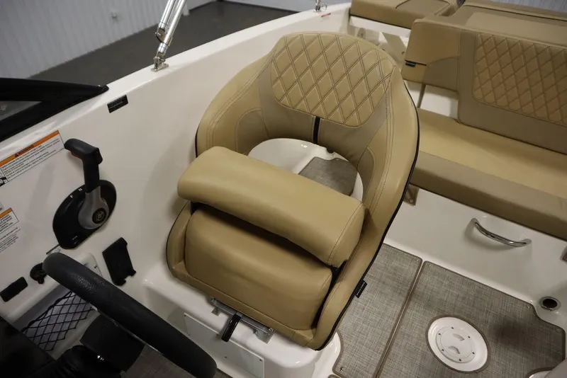 Slide: The Image of 2024 Bayliner VR5 Bowrider interior with tan seating and steering wheel. - 27