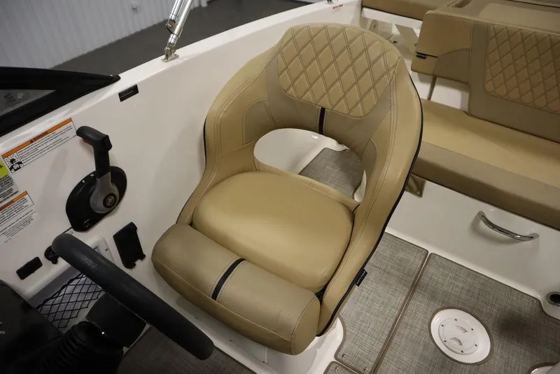 Slide: The Image of 2024 Bayliner VR5 Bowrider interior with tan seating and steering controls. - 28
