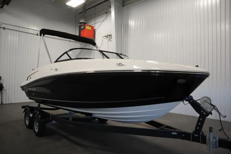 Slide: The Image of 2024 Bayliner VR5 Bowrider boat on trailer in indoor storage facility. - 3