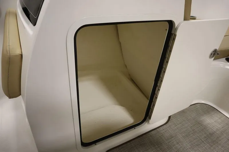 Slide: The Image of 2024 Bayliner VR5 Bowrider storage compartment with open door, showcasing interior space. - 32