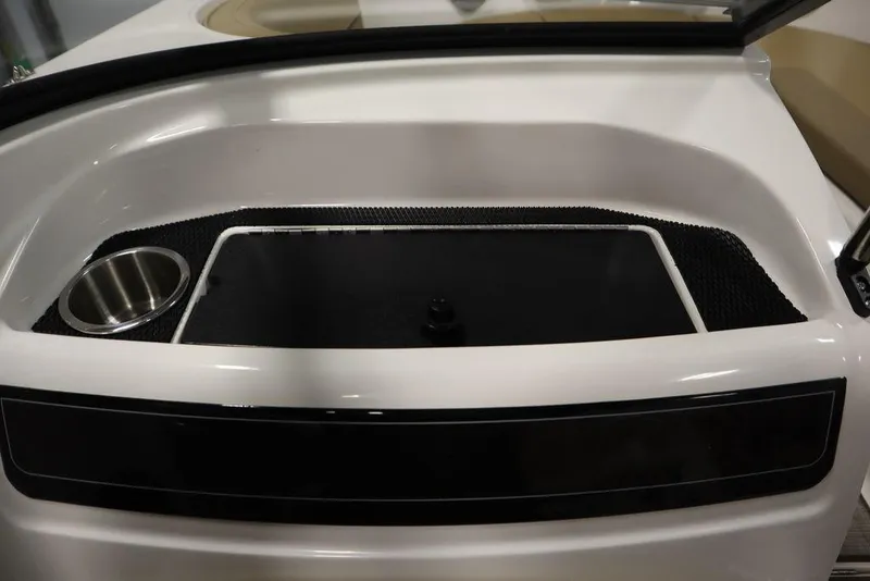 Slide: The Image of 2024 Bayliner VR5 Bowrider interior detail with cup holder and storage compartment. - 33