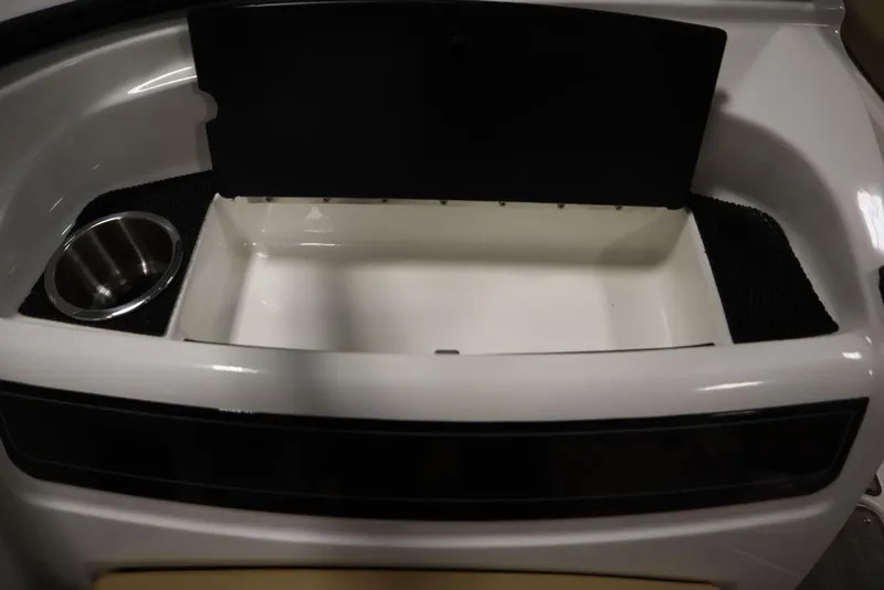 Slide: The Image of 2024 Bayliner VR5 Bowrider storage compartment with cup holder, open lid view. - 35