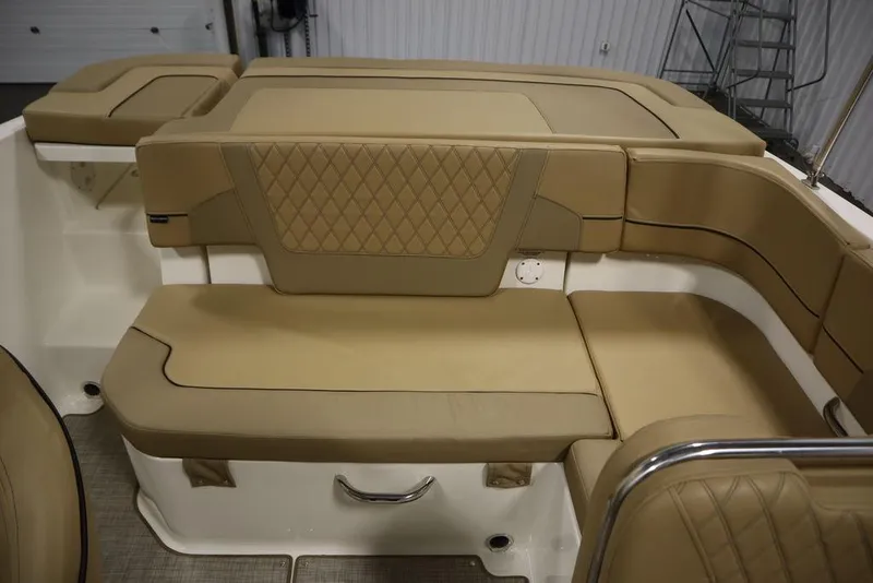 Slide: The Image of 2024 Bayliner VR5 Bowrider interior with tan cushioned seating and diamond stitching. - 38