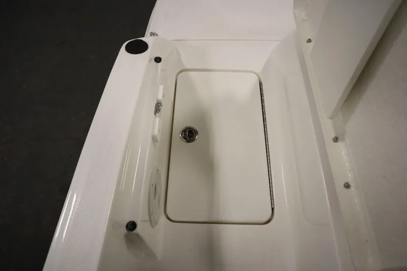 Slide: The Image of 2024 Bayliner VR5 Bowrider deck detail with storage compartment and cup holder. - 39
