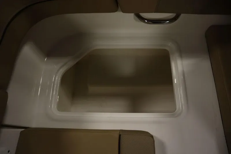 Slide: The Image of 2024 Bayliner VR5 Bowrider storage compartment with beige seating and white interior. - 44
