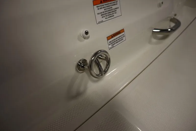 Slide: The Image of 2024 Bayliner VR5 Bowrider boat detail with chrome fittings and warning labels. - 47