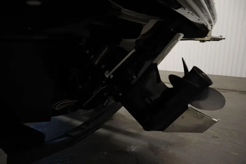 Slide: The Image of 2024 Bayliner VR5 Bowrider boat propeller and stern drive detail in a garage setting. - 48