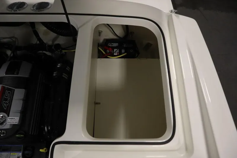 Slide: The Image of 2024 Bayliner VR5 Bowrider engine compartment with battery and storage area. - 49