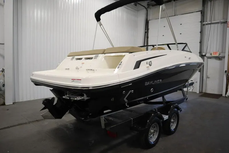 Slide: The Image of 2024 Bayliner VR5 Bowrider boat on trailer in indoor storage facility. - 6