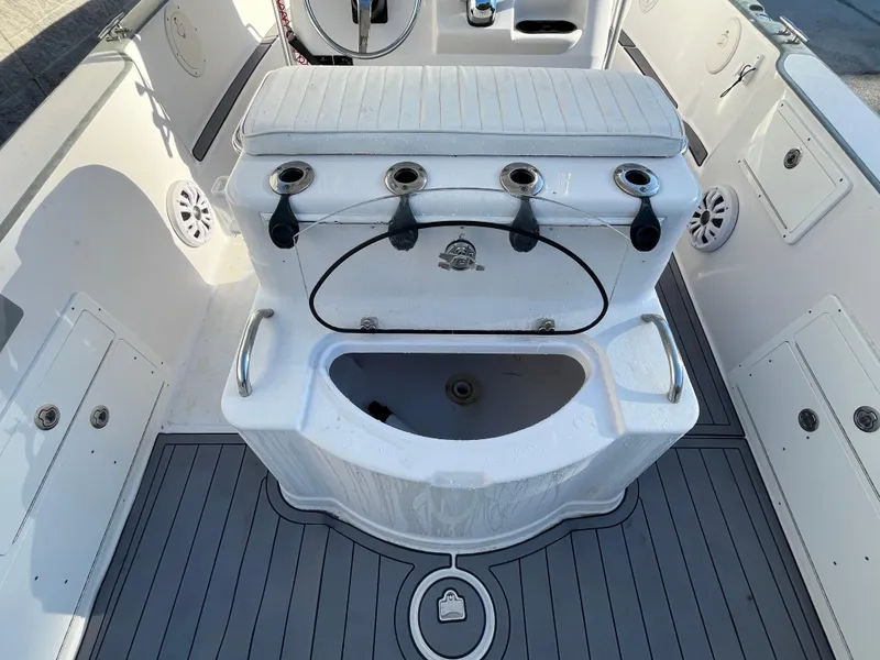 Slide: The Image of 2003 Pro-Line 25 Sport CC boat interior with fishing rod holders and storage compartments. - 11