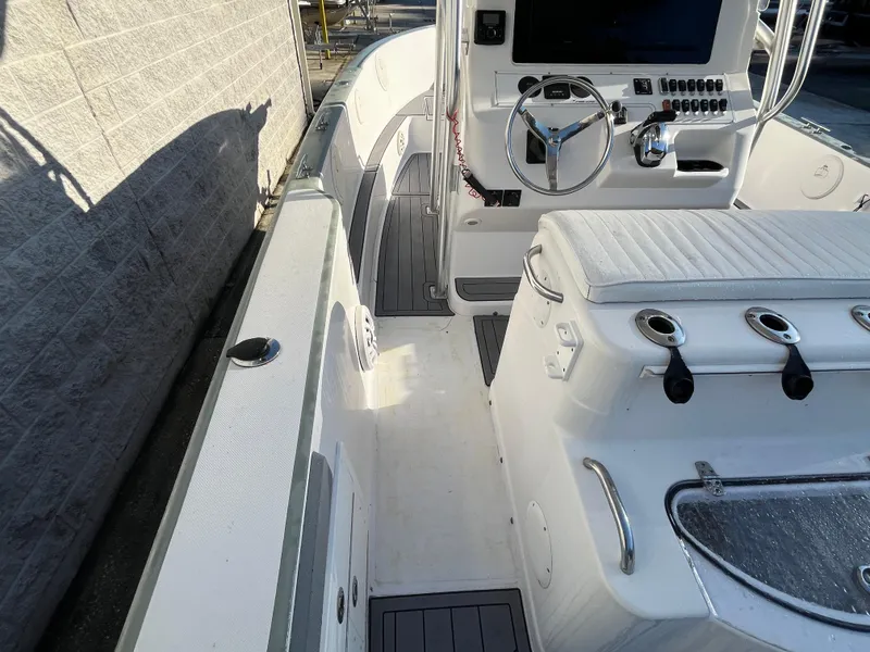 Slide: The Image of 2003 Pro-Line 25 Sport CC boat interior with steering wheel and seating. - 13